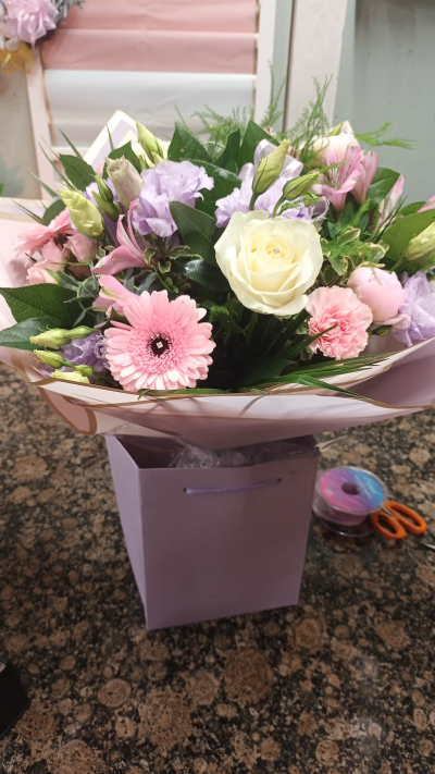 A Little Something - Show your affection with this mouth-watering mix of classical flowers delivered in a delightful gift bag or box.