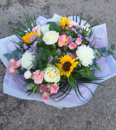 Bright Ideas - Beautiful Sunflowers and a peppering of other summer flowers and foliage. Tied in water and presented in a stylish bag. An amazing bouquet full of joy and delight ready to display and enjoy.