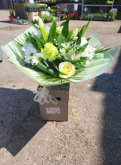Classic Harmony - Share your sentiments with this beautiful arrangement of white and green blooms complemented by lush greenery. Presented in elegant wrapping.