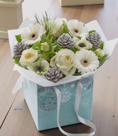 Blue Christmas - Hand-tied of fresh flowers in shades of whites and greens in a blue bag.
