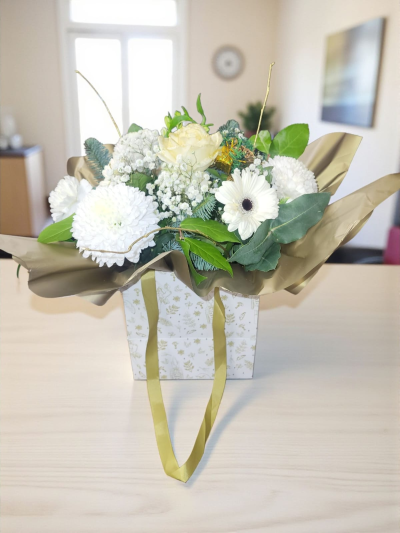 Christmas Glisten - Hand-tied of white flowers and fresh greenery.